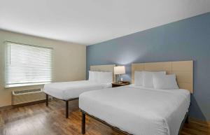 a hotel room with two beds and a window at Extended Stay America Select Suites - Tampa - Northeast in Tampa +19 photos