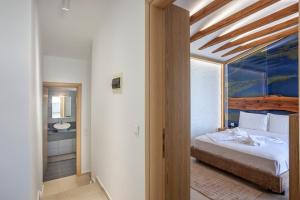 a bedroom with a bed and a bathroom at Salty Loft in Hanioti