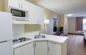 a kitchen with a sink and a microwave at Extended Stay America Suites - Fayetteville - Owen Dr in Fayetteville