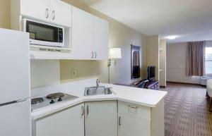 a kitchen with a sink and a microwave at Extended Stay America Select Suites - Fayetteville - Owen Dr in Fayetteville