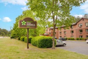 a sign in a yard in front of a building at Extended Stay America Select Suites - Raleigh - RTP - 4610 Miami Blvd in Durham