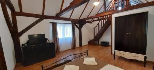 a living room with a large screen tv and a living room at Gasthof Clara in Sibiu