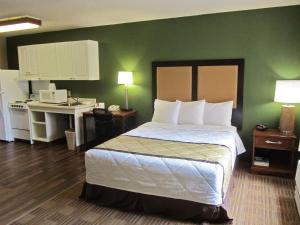 a bedroom with a bed and a desk with a computer at Extended Stay America Suites - Fayetteville - Cross Creek Mall in Fayetteville