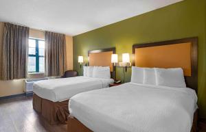 a hotel room with two beds and a room with at Extended Stay America Suites - Savannah - Midtown in Savannah