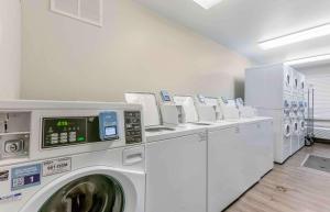 a laundry room with a row of washing machines at Extended Stay America Select Suites - El Paso - East in El Paso