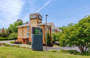 a building with a clock tower in front of it at Extended Stay America Suites - Charlotte - University Place in Charlotte