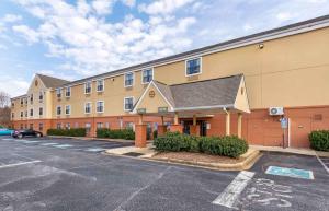 a building with a parking lot in front of it at Extended Stay America Suites - Greenville - Airport in Greenville