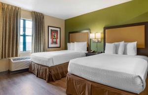 a large hotel room with two beds in it at Extended Stay America Suites - Greenville - Airport in Greenville