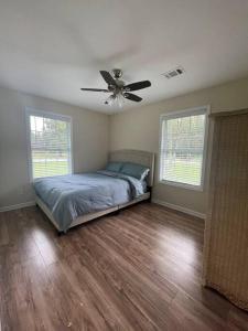 a bedroom with a bed and a ceiling fan at New Renovated 3BR/2BA home in Cobb County! in Powder Springs