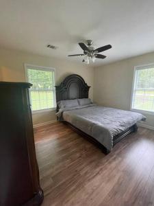 a bedroom with a bed and a ceiling fan at New Renovated 3BR/2BA home in Cobb County! in Powder Springs