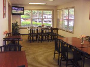 a dining room with tables and chairs and a tv at Extended Stay America - Atlanta - Marietta - Interstate N. Pkwy in Atlanta