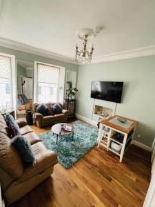 a living room with a couch and a table at Charming 2-Bedroom Apartment Located in Ayr in Ayr