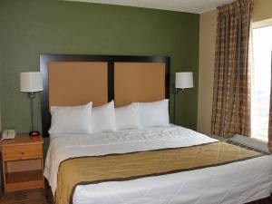 a bedroom with a large bed with white pillows at Extended Stay America Suites - Atlanta - Marietta - Powers Ferry Rd in Atlanta