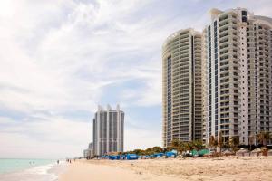 two tall buildings on the beach next to the ocean at Marenas Beach Resort in Sunny Isles Beach