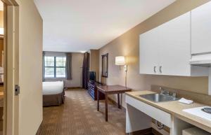 a kitchen with a sink and a bed in a room at Extended Stay America Suites - Philadelphia - Exton in Exton