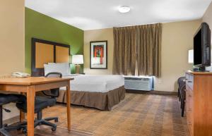 a hotel room with a bed and a desk at Extended Stay America Suites - Pittsburgh - Airport in Imperial