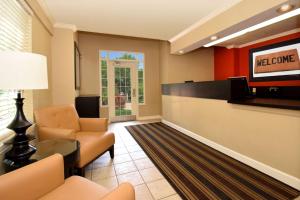 a lobby with a waiting room with a television and chairs at Extended Stay America Suites - Baltimore - BWI Airport - International Dr in Linthicum Heights