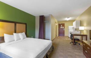a hotel room with a large bed and a desk at Extended Stay America Suites - Baltimore - BWI Airport - Aero Dr in Linthicum Heights