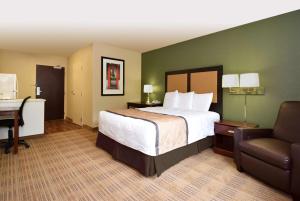 a hotel room with a bed and a desk and a chair at Extended Stay America Suites - Baltimore - Glen Burnie in Glen Burnie