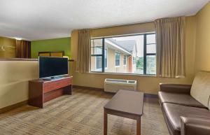 a living room with a couch and a flat screen tv at Extended Stay America Suites - Baltimore - Timonium in Timonium