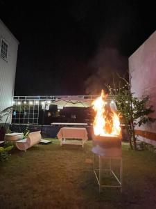 a fire in a container in a yard at night at Lavender House in Ấp Kim Thạch