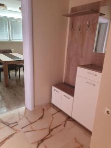 a kitchen with a table and a white refrigerator at Граф игнатиев луксозен апартамент с топ гледка in Yambol