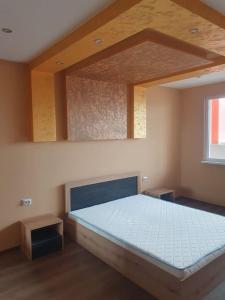 a bedroom with a large bed in a room at Граф игнатиев луксозен апартамент с топ гледка in Yambol