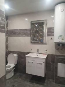 a bathroom with a toilet and a sink at Граф игнатиев луксозен апартамент с топ гледка in Yambol +5 photos