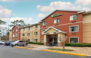 a hotel with cars parked in a parking lot at Extended Stay America Suites - Daytona Beach - International Speedway in Daytona Beach