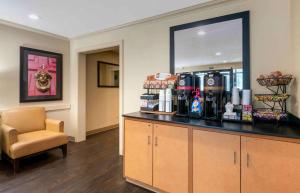 a room with a counter with a chair and a mirror at Extended Stay America Suites - Daytona Beach - International Speedway in Daytona Beach