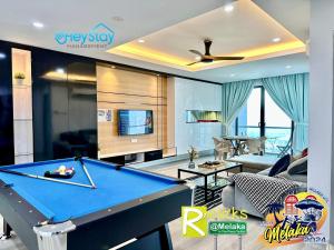 a living room with a pool table in it at Atlantis Residences Melaka by HeyStay Management(2) in Melaka