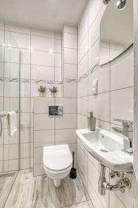 a white bathroom with a toilet and a sink at 3Beds in CITYCENTER Fast Wifi in Warsaw