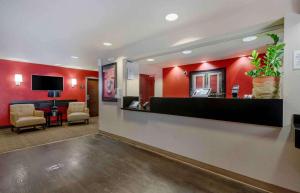 a lobby with a waiting room with red walls at Extended Stay America Suites - Orlando - Lake Mary - 1036 Greenwood Blvd in Lake Mary