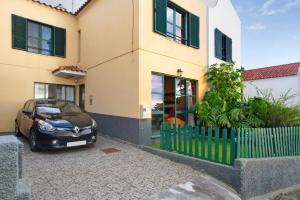 a small car parked in front of a house at Slice of Paradise- Palheiro de Golf in Funchal