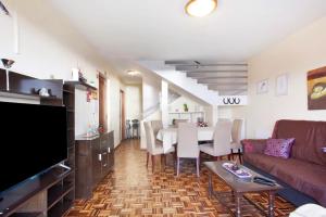 a living room with a couch and a table at Slice of Paradise- Palheiro de Golf in Funchal