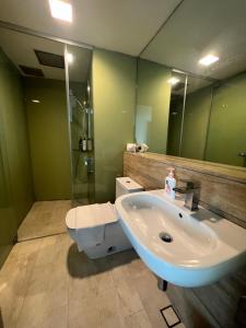 a bathroom with a sink and a shower and a toilet at Vortex suites klcc by Hafizah suites in Kuala Lumpur