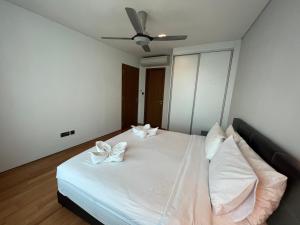 a bedroom with a white bed with two white pillows at Vortex suites klcc by Hafizah suites in Kuala Lumpur