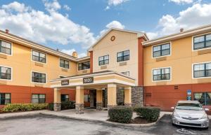 a building with a car parked in a parking lot at Extended Stay America Suites - Orlando - Orlando Theme Parks - Major Blvd in Orlando