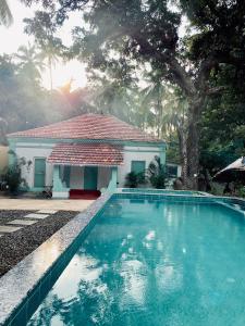 a swimming pool in front of a house at Casa Happy Dervish, 2mins away from the beach in Anjuna