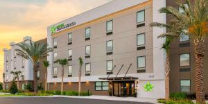 uma representação da frente de um hotel com palmeiras em Extended Stay America Premier Suites - Orlando - Sanford em Sanford