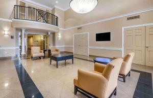 a lobby with chairs and a table and a tv at Extended Stay America Suites - Orlando - Southpark - Commodity Circle in Orlando