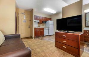 a large living room with a flat screen tv at Extended Stay America Suites - Orlando - Southpark - Commodity Circle in Orlando