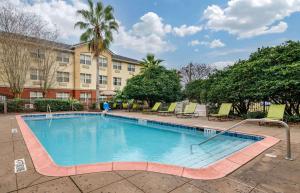 a large swimming pool in front of a building at Extended Stay America Suites - Orlando - Southpark - Commodity Circle in Orlando