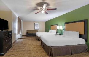 a hotel room with two beds and a ceiling fan at Extended Stay America Suites - Jacksonville - Lenoir Avenue East in Jacksonville
