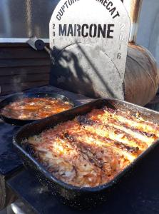 two pans of food being cooked on a grill at Casa Marcone in Partizanii