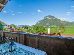 a table on a balcony with a view of a mountain at Hilde 1 in Kirchdorf in Tirol