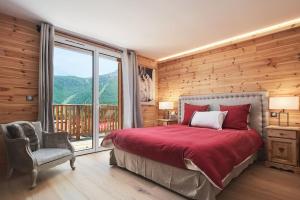 a bedroom with a bed and a large window at FRGK " Luxury Chalet" in Saint-Étienne-de-Tinée