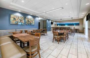a dining room with wooden tables and chairs at Extended Stay America Premier Suites - Lakeland - I-4 in Lakeland