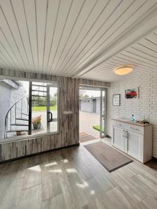 a living room with a kitchen and a staircase at Apartamenty Molle in Åkirkeby
