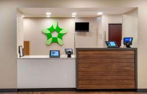 a reception desk with a green star on a wall at Extended Stay America Suites - Fort Lauderdale - Plantation in Plantation